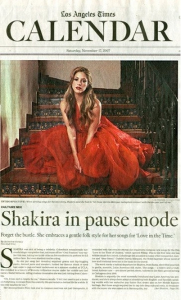 Los Angeles Times Calendar feature showing Shakira seated on stairs in a red gown.
