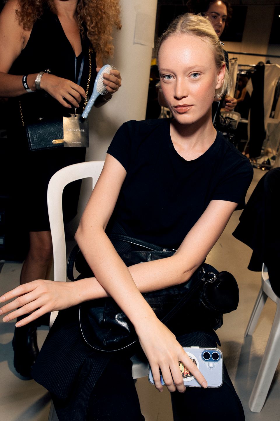 Model seated backstage before the show