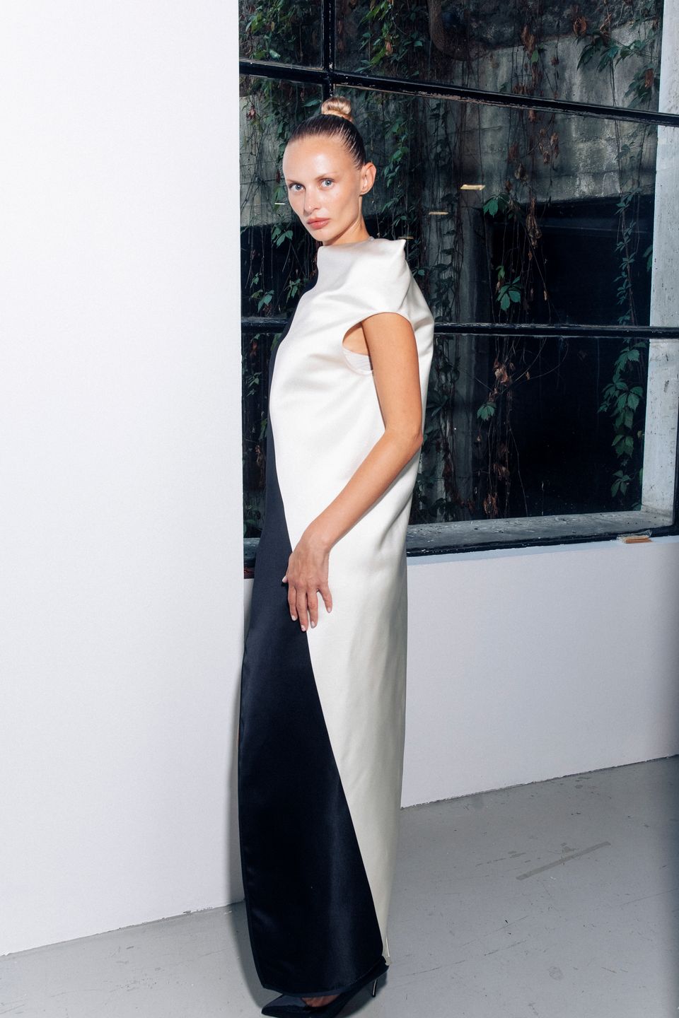 Model in a white top and black skirt at the show